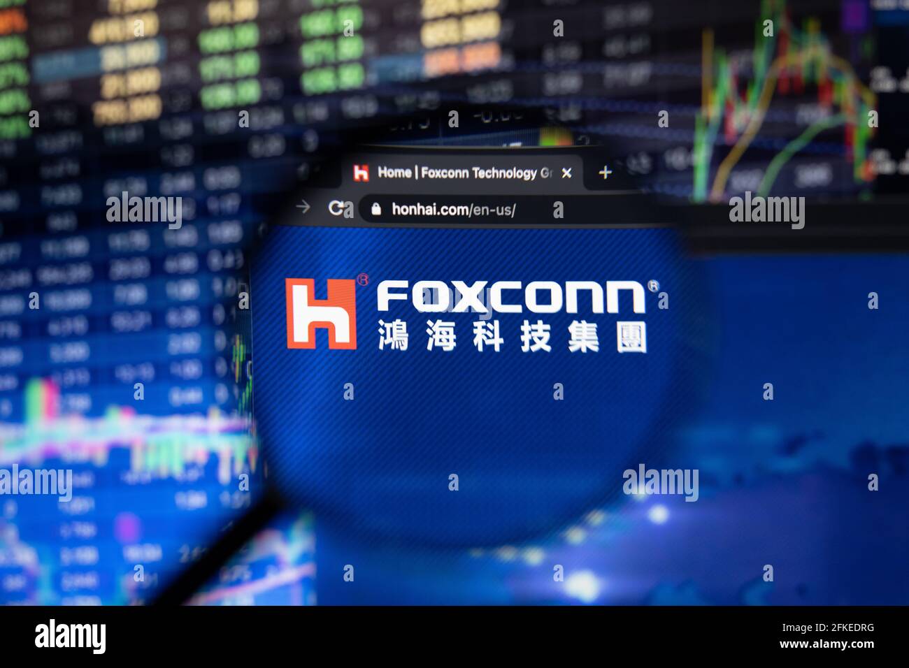 Hon Hai Precision Industry company logo on a website with blurry stock market developments in the background Stock Photo