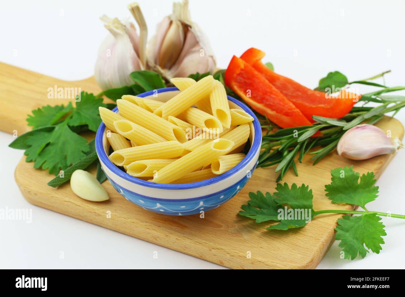 Selection of ingredients for Italian pasta on wooden board, closeup Stock Photo