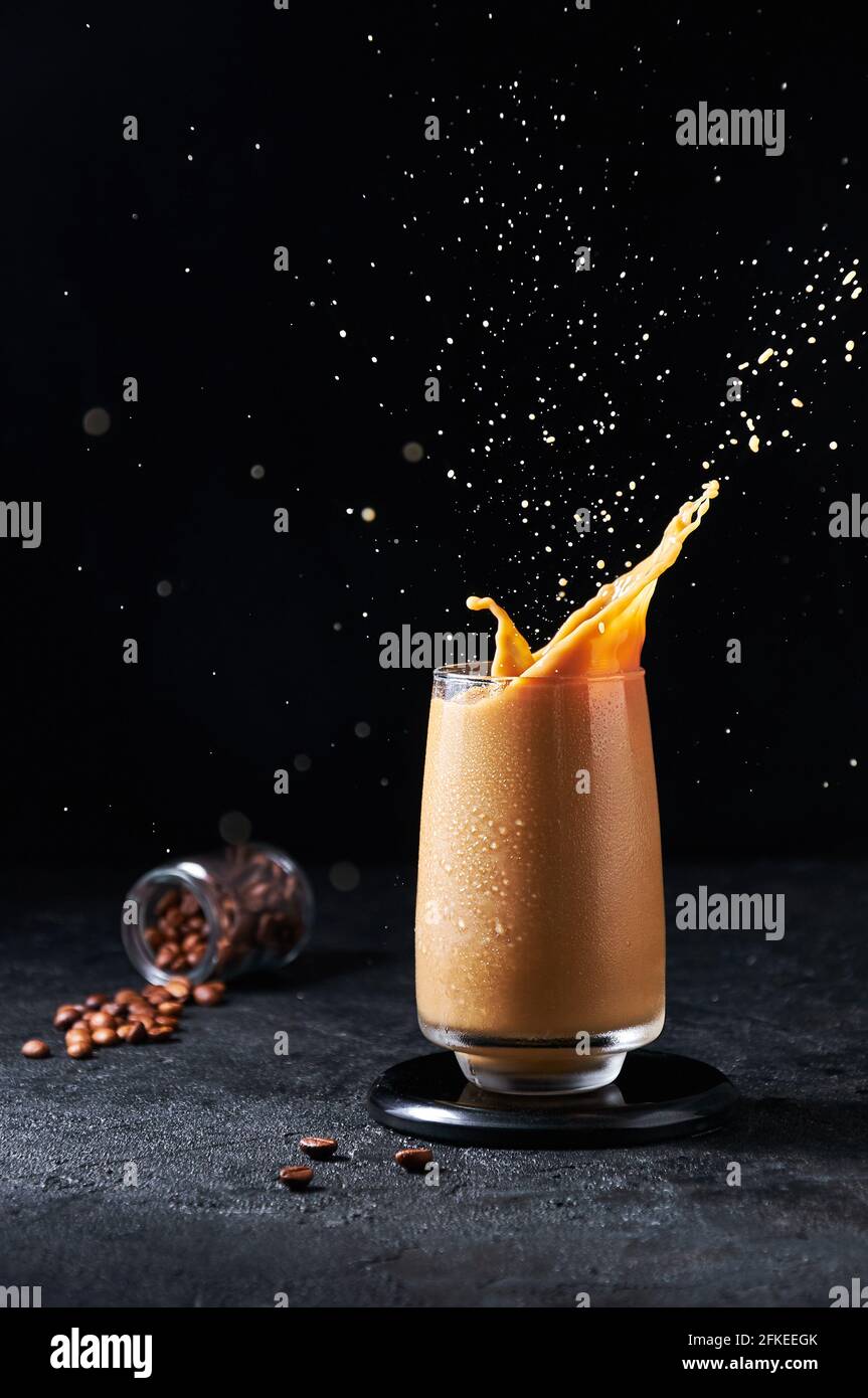 https://c8.alamy.com/comp/2FKEEGK/iced-coffee-with-splash-in-tall-glass-on-dark-background-concept-refreshing-summer-drink-2FKEEGK.jpg