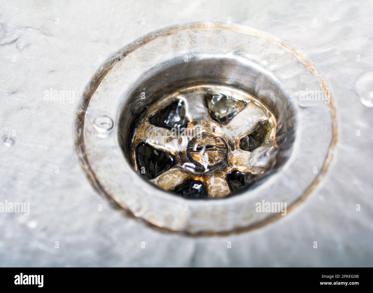 Some Water Pouring Down A Dirty Drain In A Kitchen Sink Stock Photo Alamy