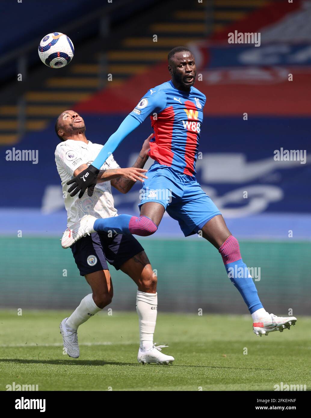 Manchester City's Raheem Sterling and Crystal Palace's Cheikhou Kouyate (right) battle for the ball during the Premier League match at Selhurst Park, London. Issue date: Saturday May 1, 2021. Stock Photo