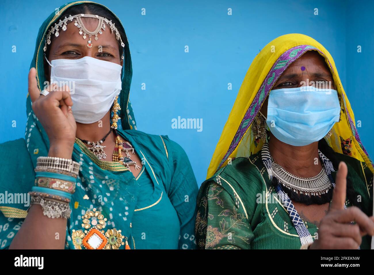 Indian females in traditional clothes wearing medical masks Stock Photo