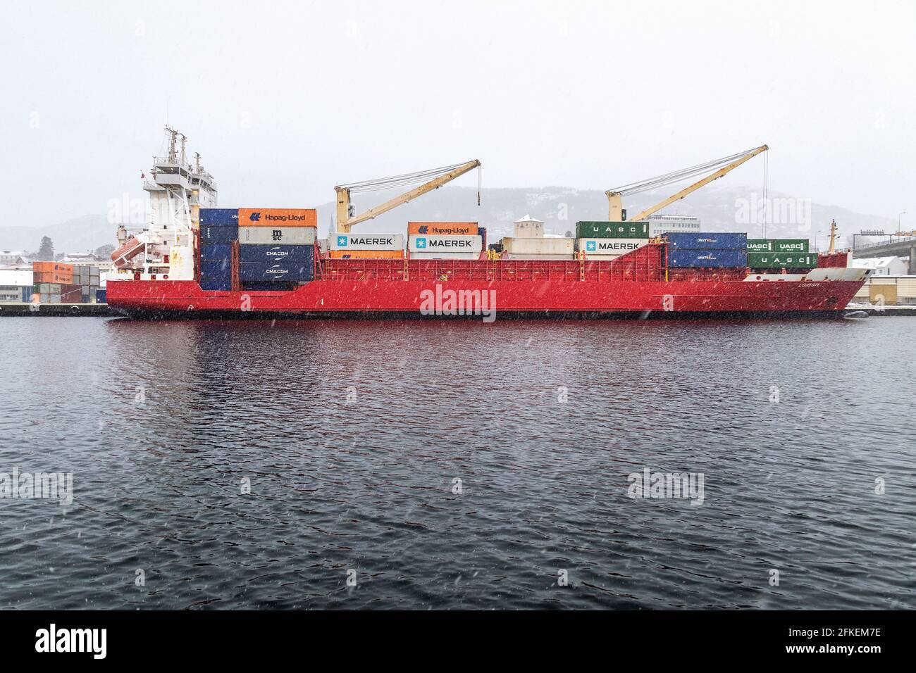 Container vessel Coneste at Frieleneskaien terminal,  in the port of Bergen, Norway. January snowstorm Stock Photo
