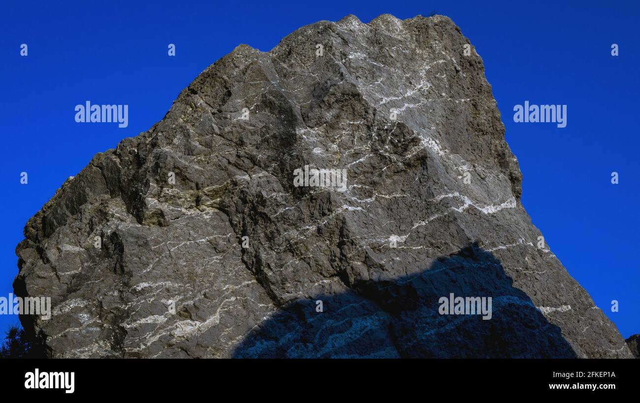 Gray granite rock against the blue sky Stock Photo - Alamy
