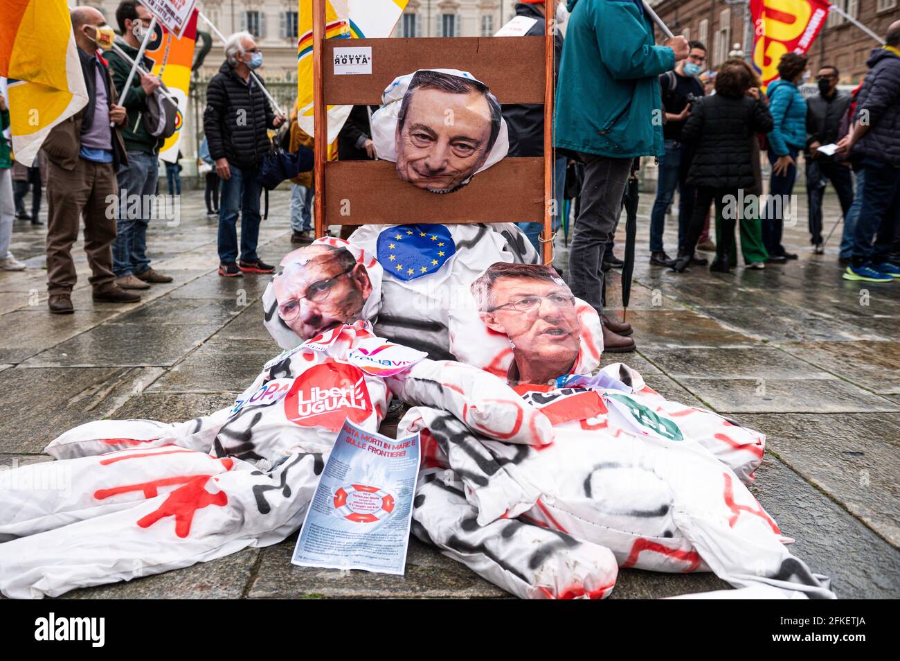 Turin, Italy. 01 May 2021. Puppets depicting Mario Draghi, Enrico Letta and Maurizio Landini are guillotined during a May Day rally (also known as International Workers' Day or Labour Day). May Day occurs every year on 1 May and it is used to mark the fight for workers' rights across the world . Credit: Nicolò Campo/Alamy Live News Stock Photo