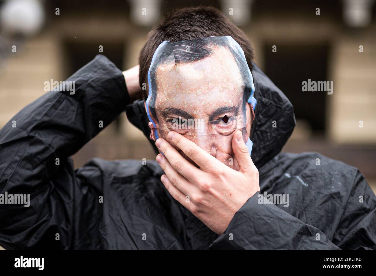 Turin, Italy. 01 May 2021. A demonstrator wears a mask depicting Italian Prime Minister Mario Draghi during a May Day rally (also known as International Workers' Day or Labour Day). May Day occurs every year on 1 May and it is used to mark the fight for workers' rights across the world . Credit: Nicolò Campo/Alamy Live News Stock Photo