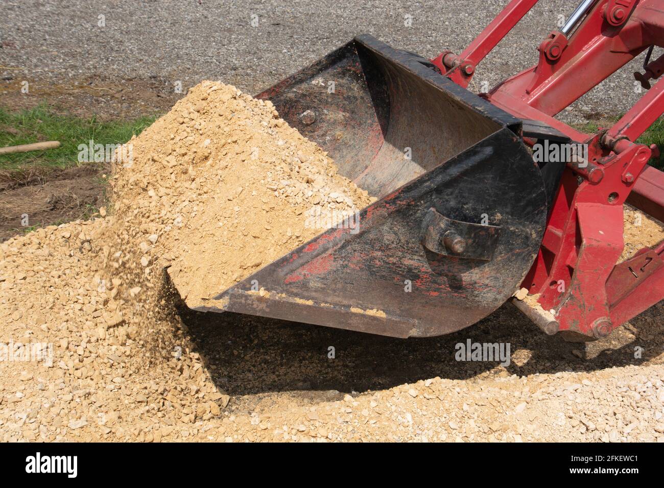 old excavator shovel of an tractor does gravel pick up on the shovel