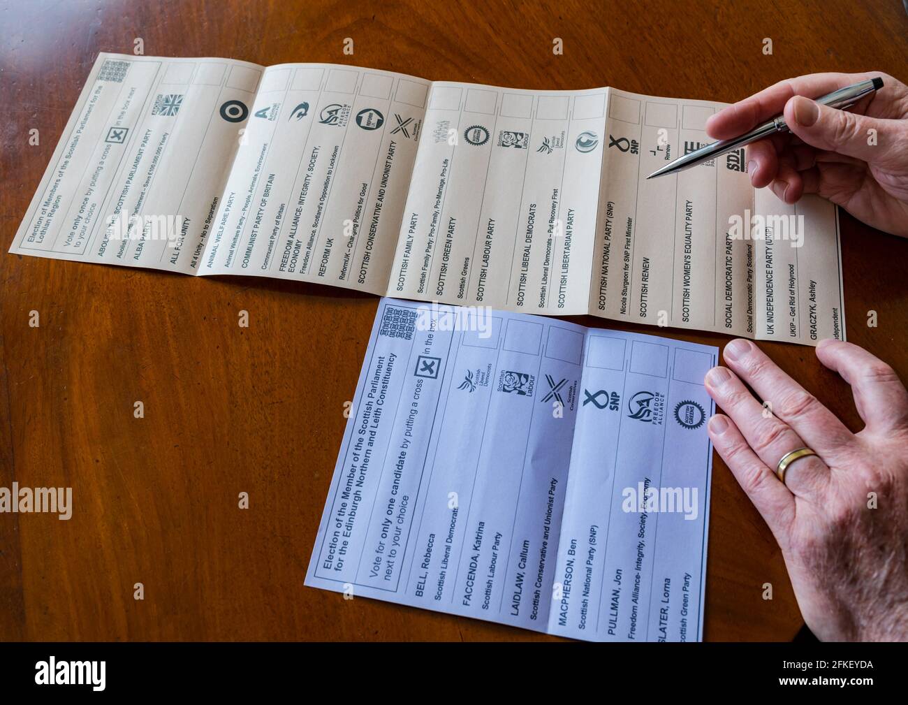 Man voting on ballot paper in 2021 Scottish parliament election for Edinburgh North & Leith constituency & Regional candidates list, Scotland, UK Stock Photo