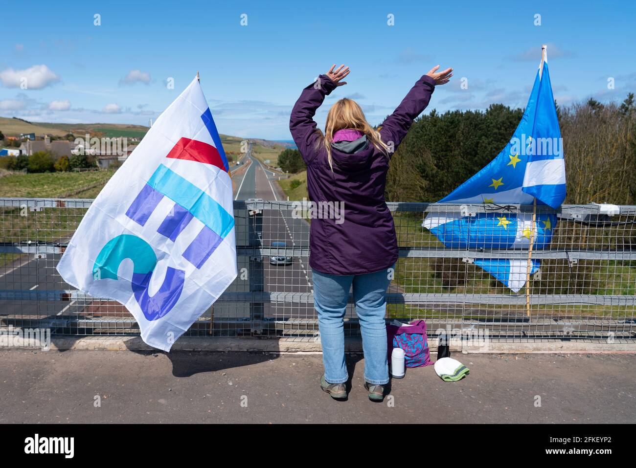 Lamberton, Scottish Borders, Scotland, UK. 1 May 2021. Pro Scottish Independence supporters attach flags and signs to bridges crossing the A1 highway and wave to passing motorists today. Iain Masterton/Alamy Live News Stock Photo