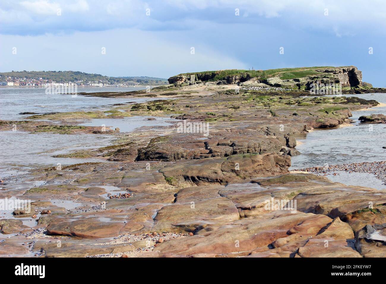 Sandstone Causeway to Middle Eye from Hilbre Island Appears As Tide Ebbs, The Wirral, Dee Estuary Stock Photo
