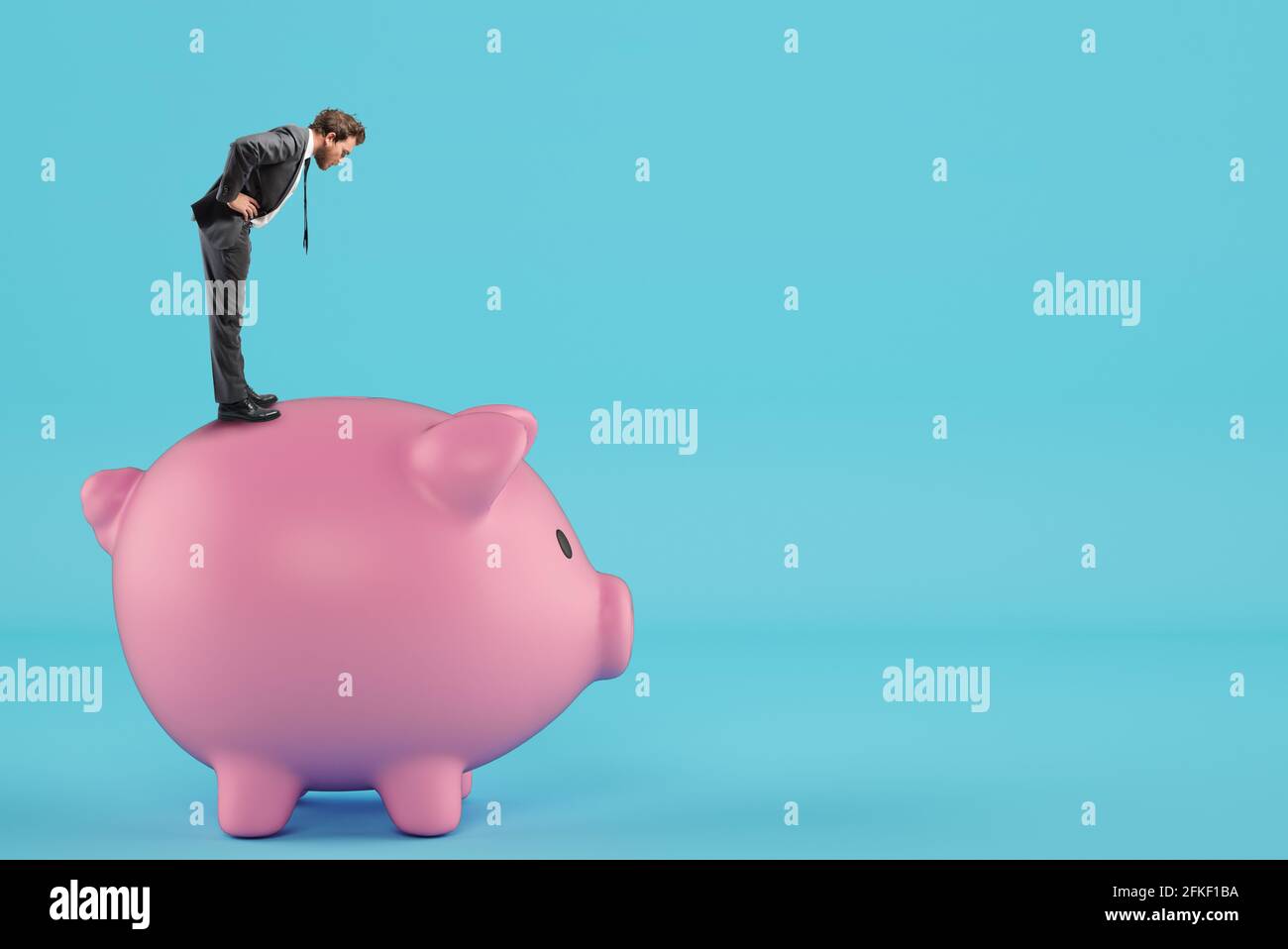 Man looks inside the piggy bank looking for money Stock Photo - Alamy