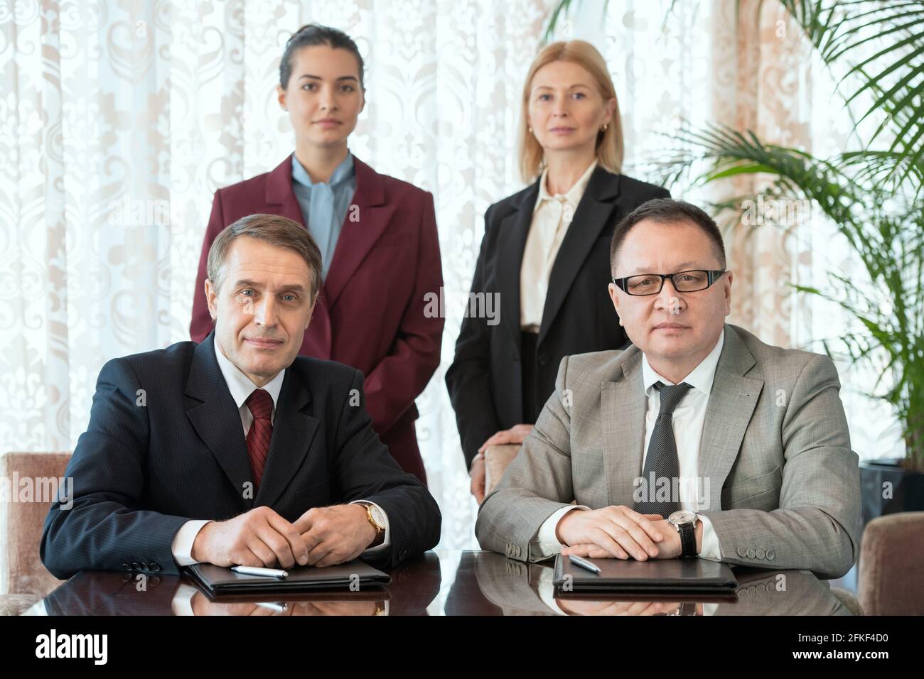 Four professional men in suits hi-res stock photography and images - Alamy