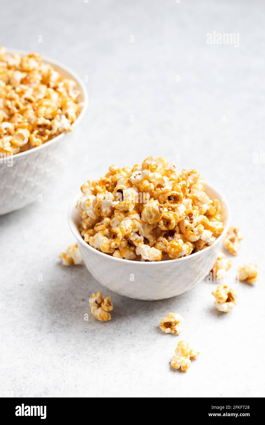 Caramel Popcorn in a bowl on a white background. Stock Photo