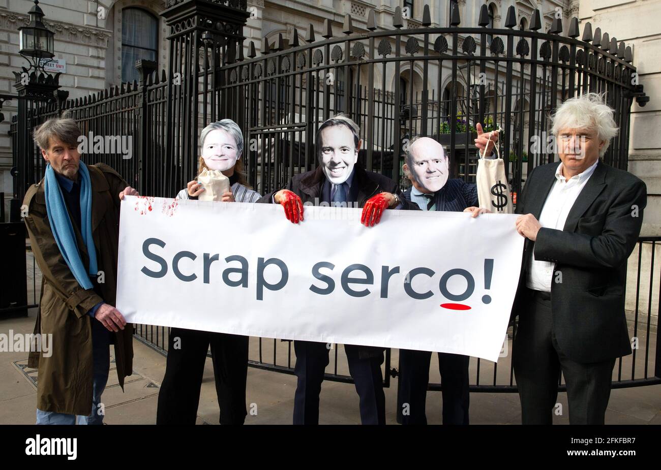 A demonstration at Downing Street asking the Government to' Scrap Serco'. Serco has been charged with fraud and false accounting as profits soar. Stock Photo