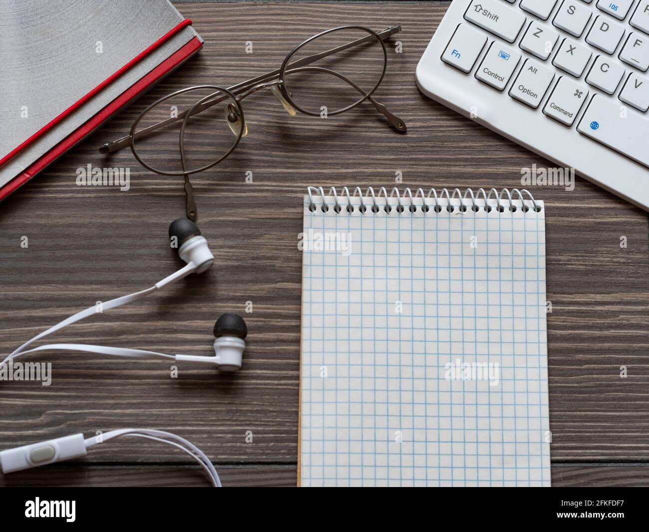 High angle view of computer keyboard and notepad on table Stock Photo