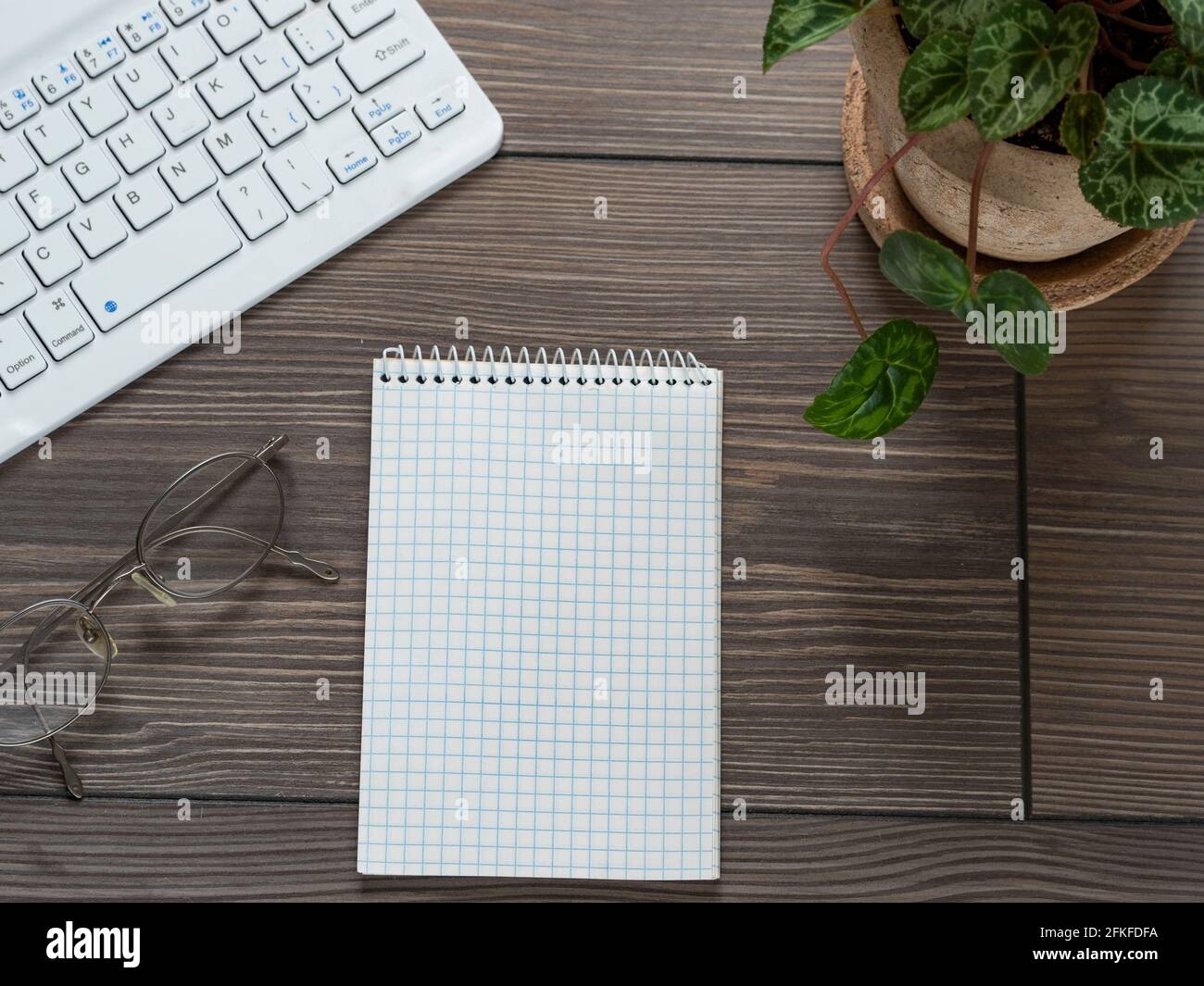 High angle view of computer keyboard and notepad on table Stock Photo