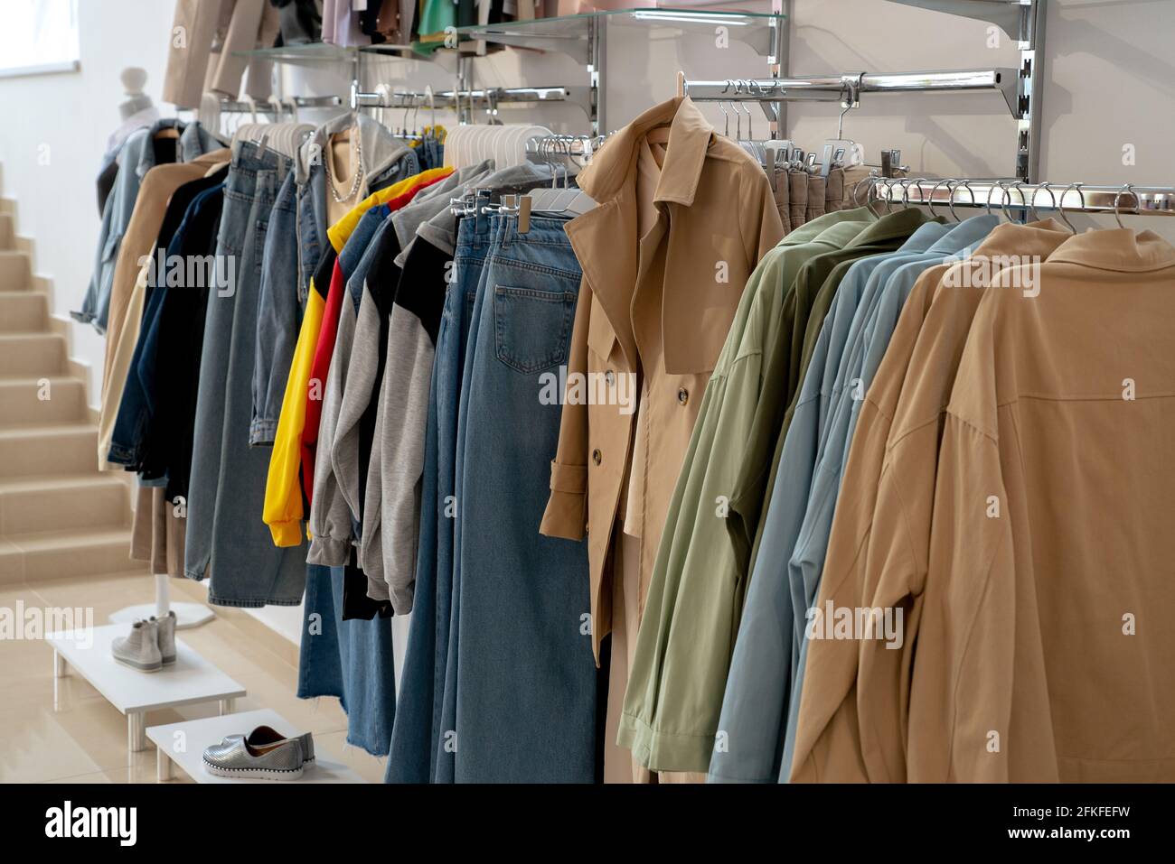 Clothes hangers with colorful clothes in a women shop. Summer sa Stock  Photo by ©Volurol 115457946