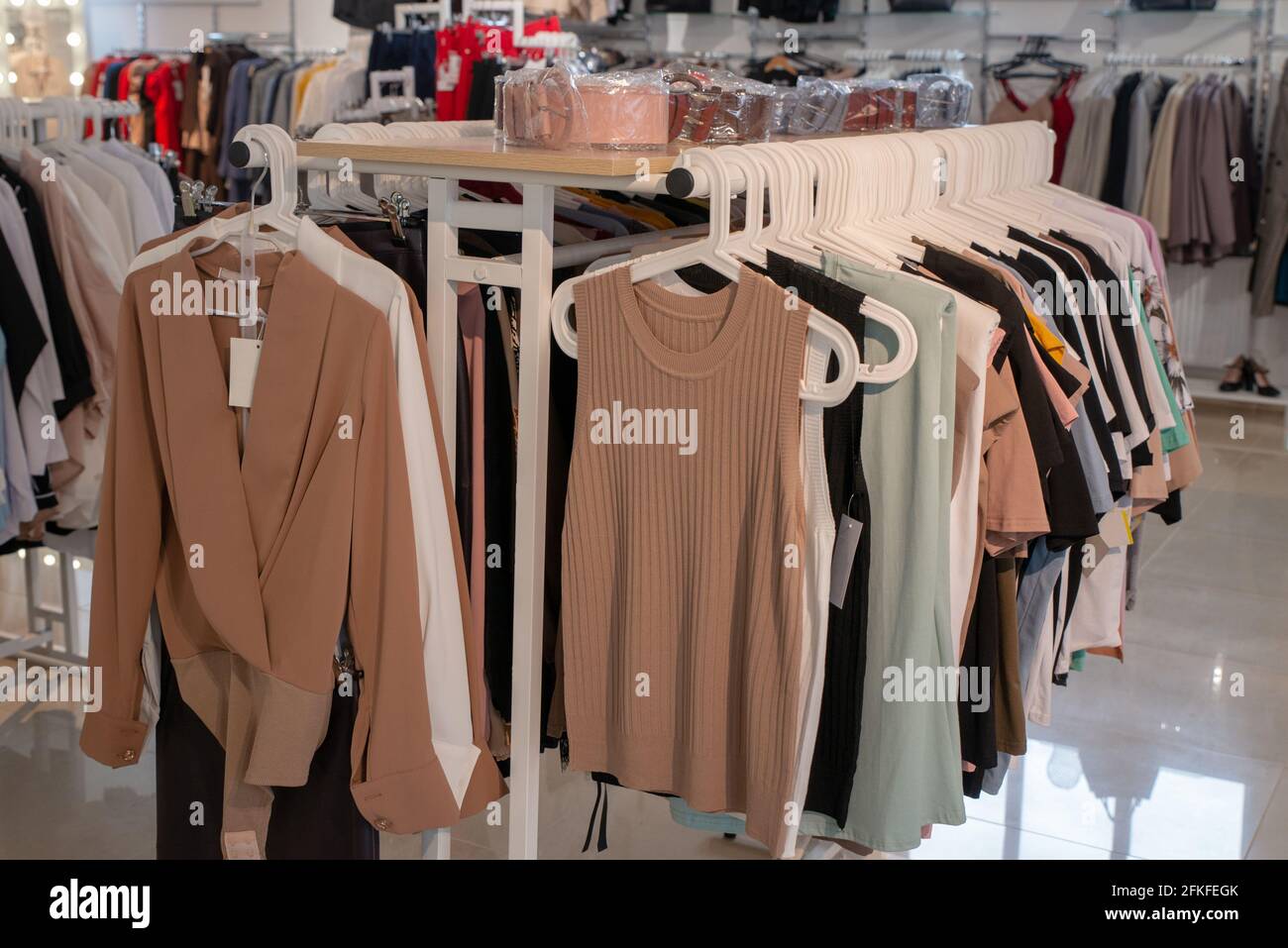 Clothes hangers with colorful clothes in a women shop. Summer sa Stock  Photo by ©Volurol 115457954