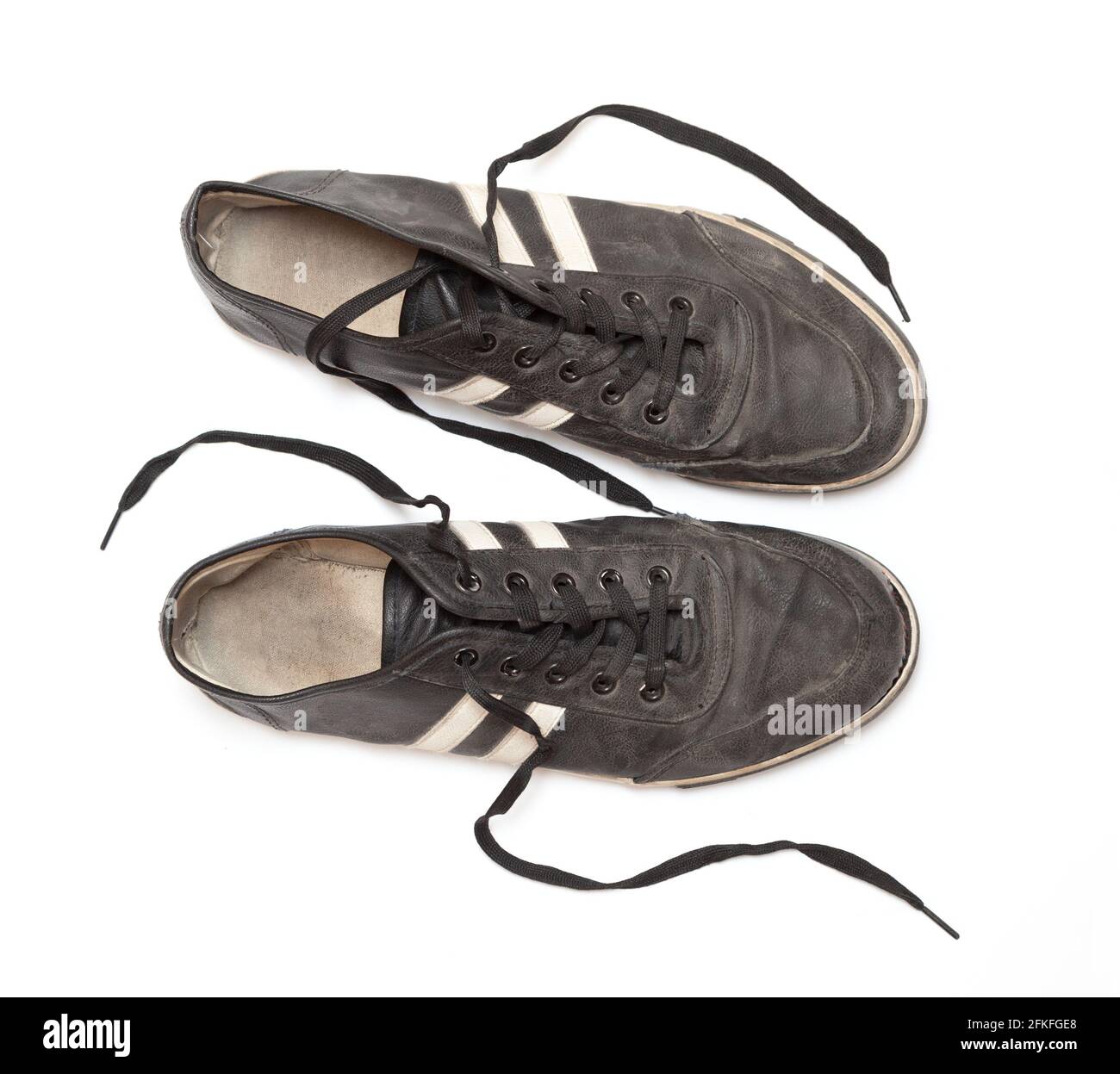 Dirty old black sneakers isolated on a white background Stock Photo - Alamy