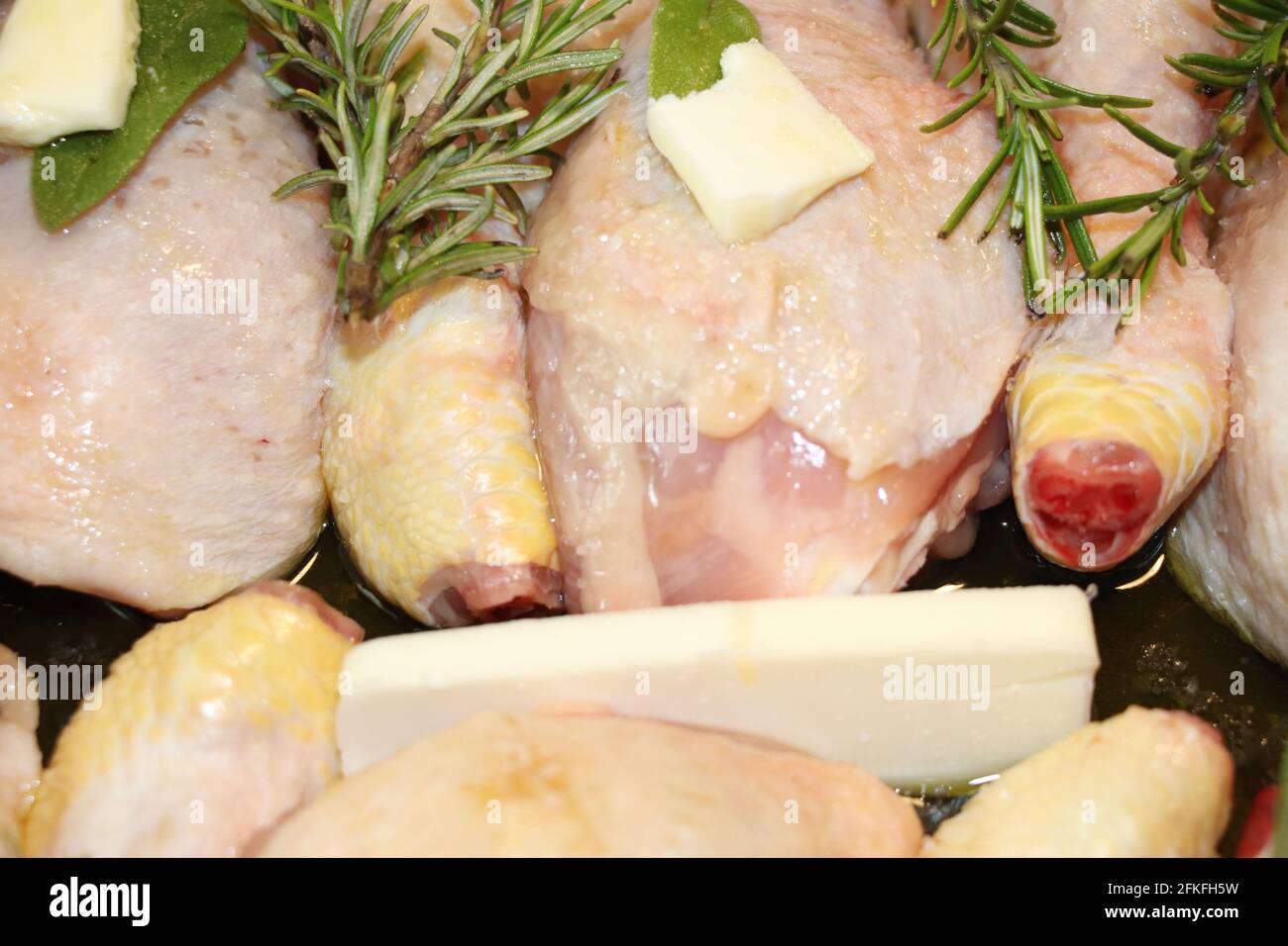 raw chicken meat with rosemary and butter Stock Photo
