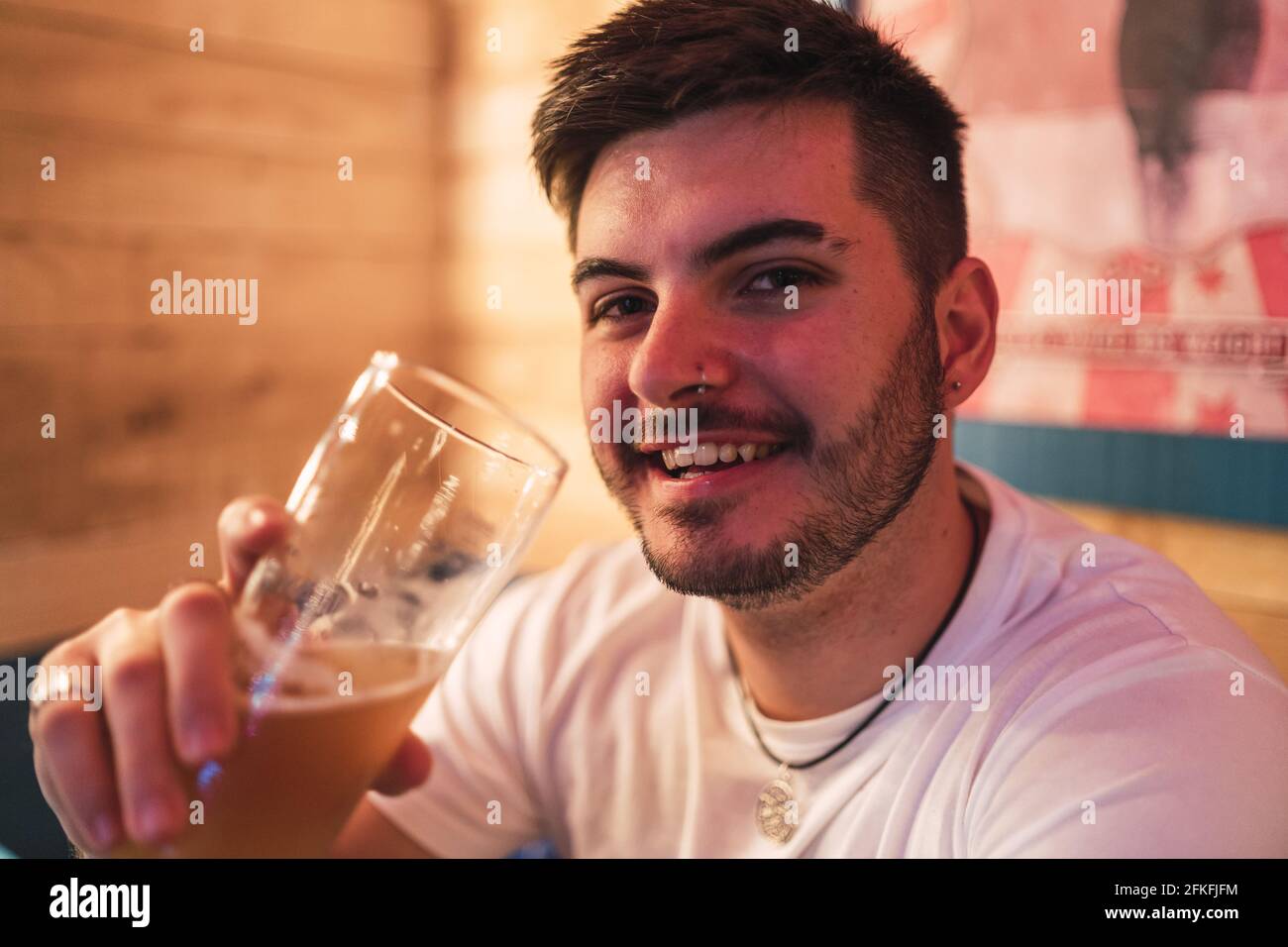 Young Spanish guy drinking beer in the pub Stock Photo