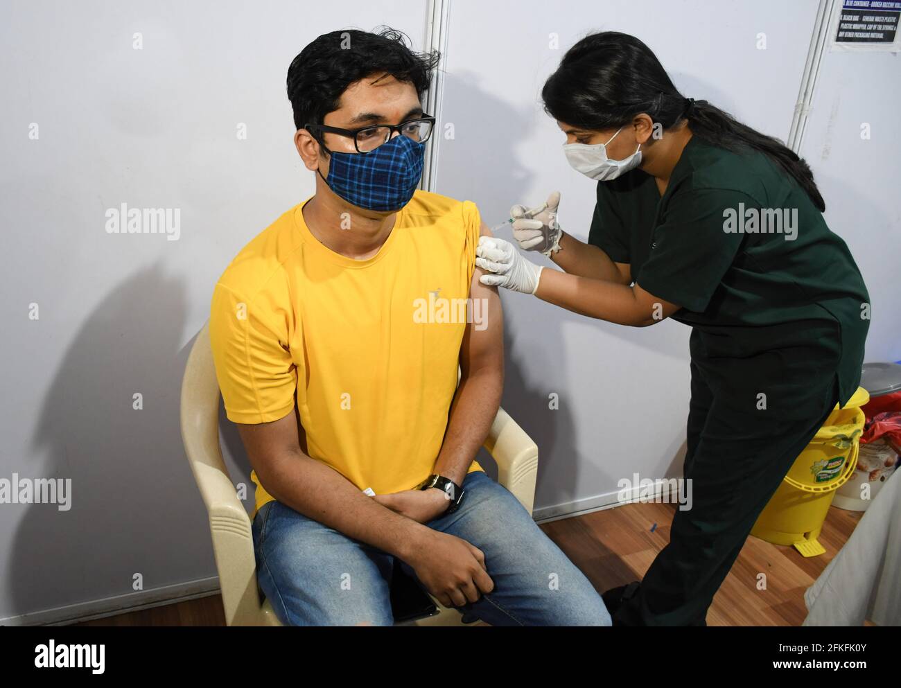 Mumbai, India. 01st May, 2021. A man wearing a face mask gets a dose of Covishield vaccine at Bandra Kurla Complex (BKC) vaccination center in Mumbai. Vaccination drive for 18-44 years age group started on 1st May 2021. only those people who were eligible for the vaccine received confirmation about their registration on the phone. Credit: SOPA Images Limited/Alamy Live News Stock Photo