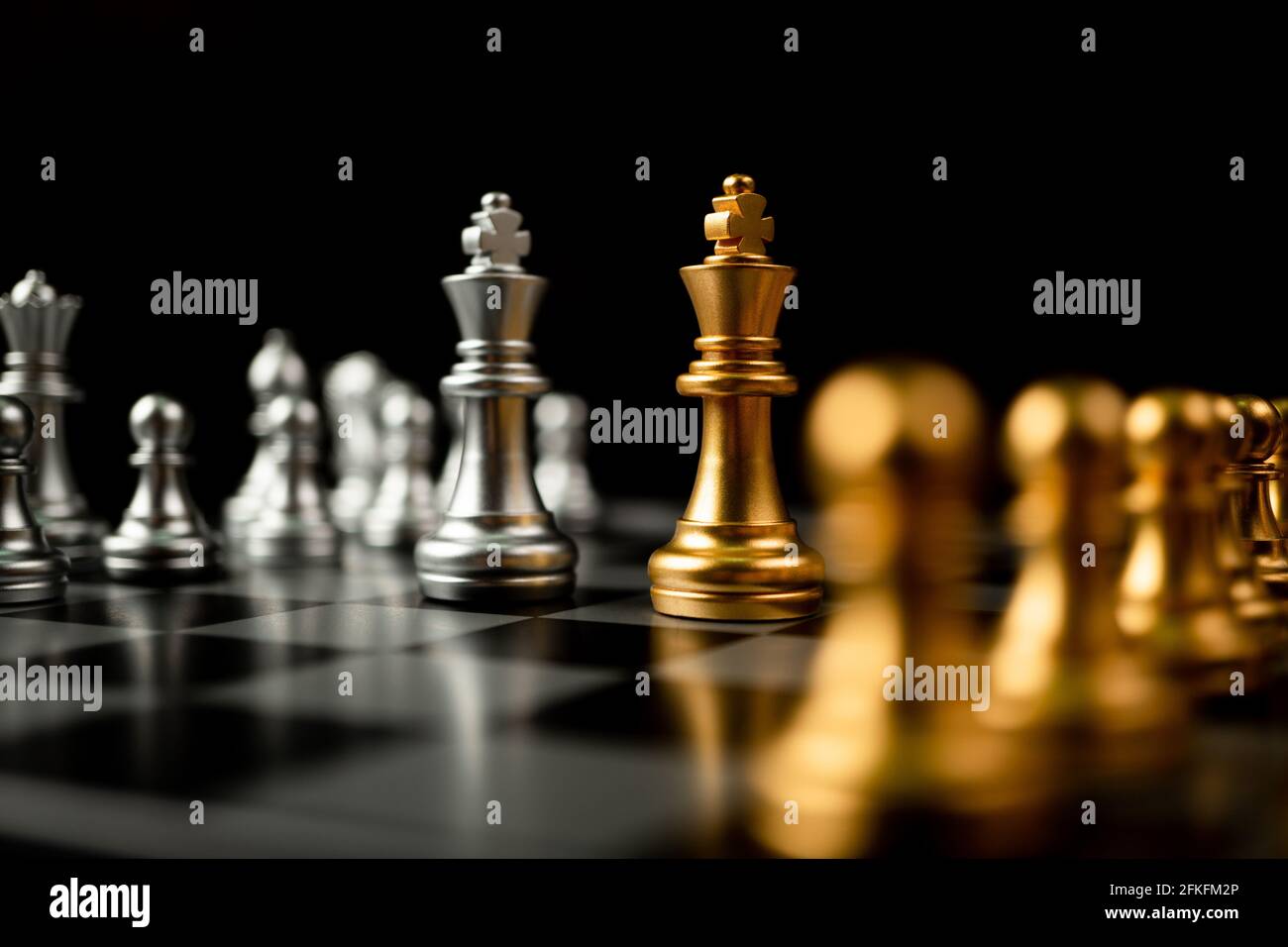 Golden Chess King In Front Of A Checkered Board Stock Photo