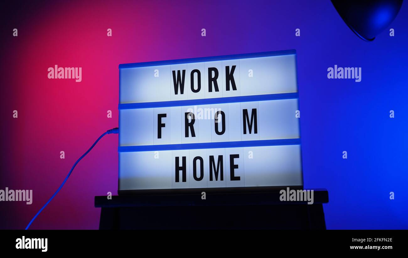 Work from home light box in studio. WFH Text on lightbox. Represent work from home for social distancing concept during coronavirus pandemic. WFH mess Stock Photo