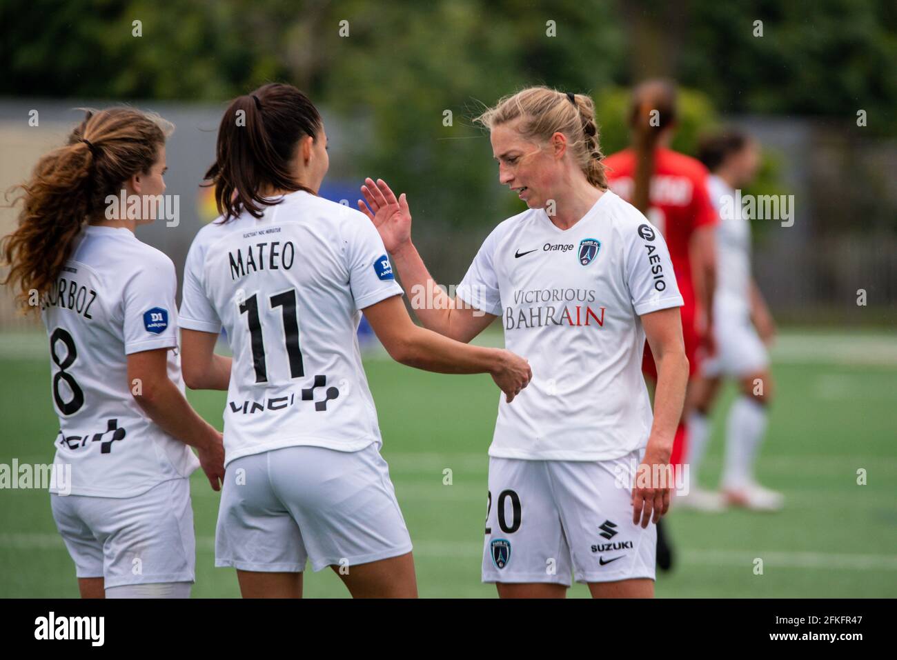 Boulogne-Billancourt, France, 1st May 2021, Daphne Corboz of Paris FC,  Clara Mateo of Paris FC and Linda Sallstrom of Paris FC celebrate the  victory after the Women's French championship D1 Arkema football