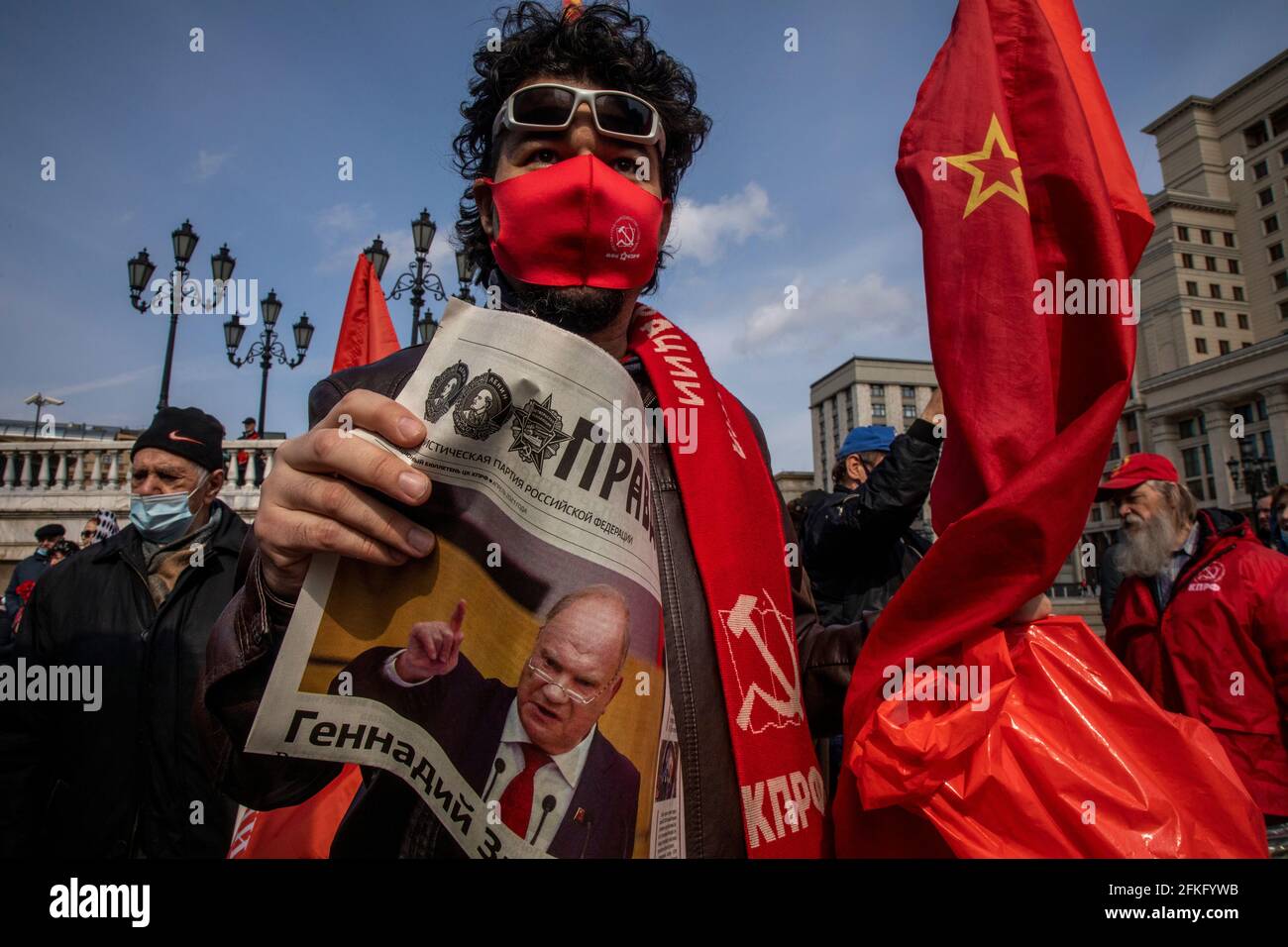Moscow, Russia. 22nd of April, 2021 Communist supporter reads 'Pravda' (Eng: Truth) newspaper at Manegnaya square in central Moscow before visit the Mausoleum of the Soviet founder Vladimir Lenin to mark the 151st anniversary of his birth, Russia. On the front page of the newspaper is a portrait of the Communist Party leader Gennady Zyuganov. The Pravda is Russian broadsheet newspaper, formerly the official newspaper of the Communist Party of the Soviet Union, when it was one of the most influential papers in the country with a circulation of 11 million Stock Photo