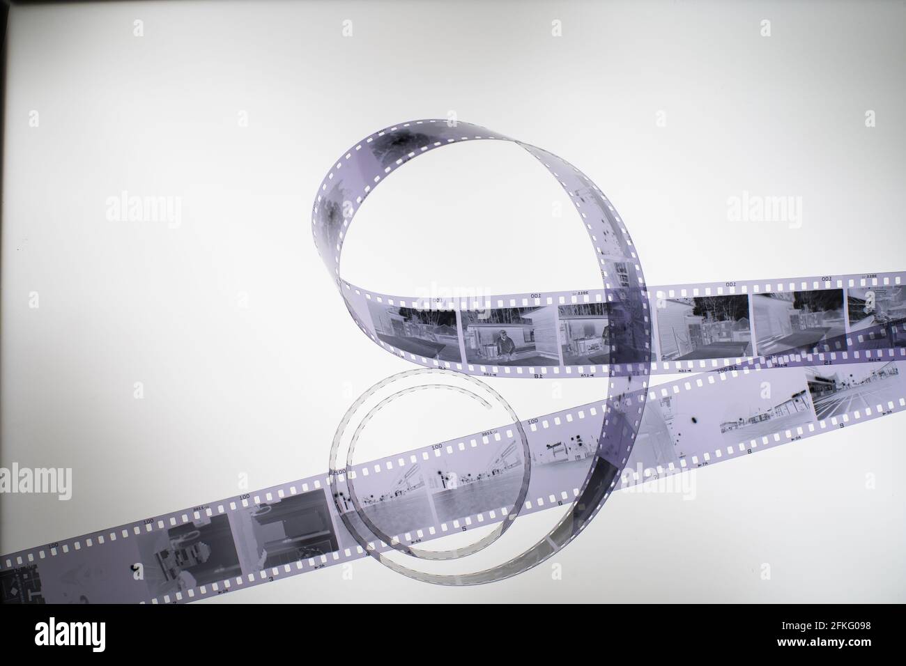 Analog black and white 35mm negative film strip on light table, top