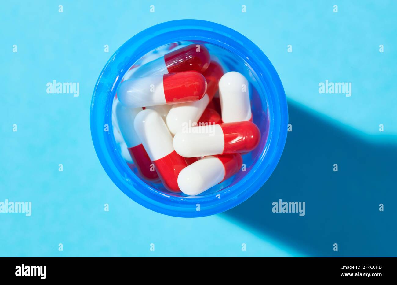 Bottles of  capsules on blue background Stock Photo