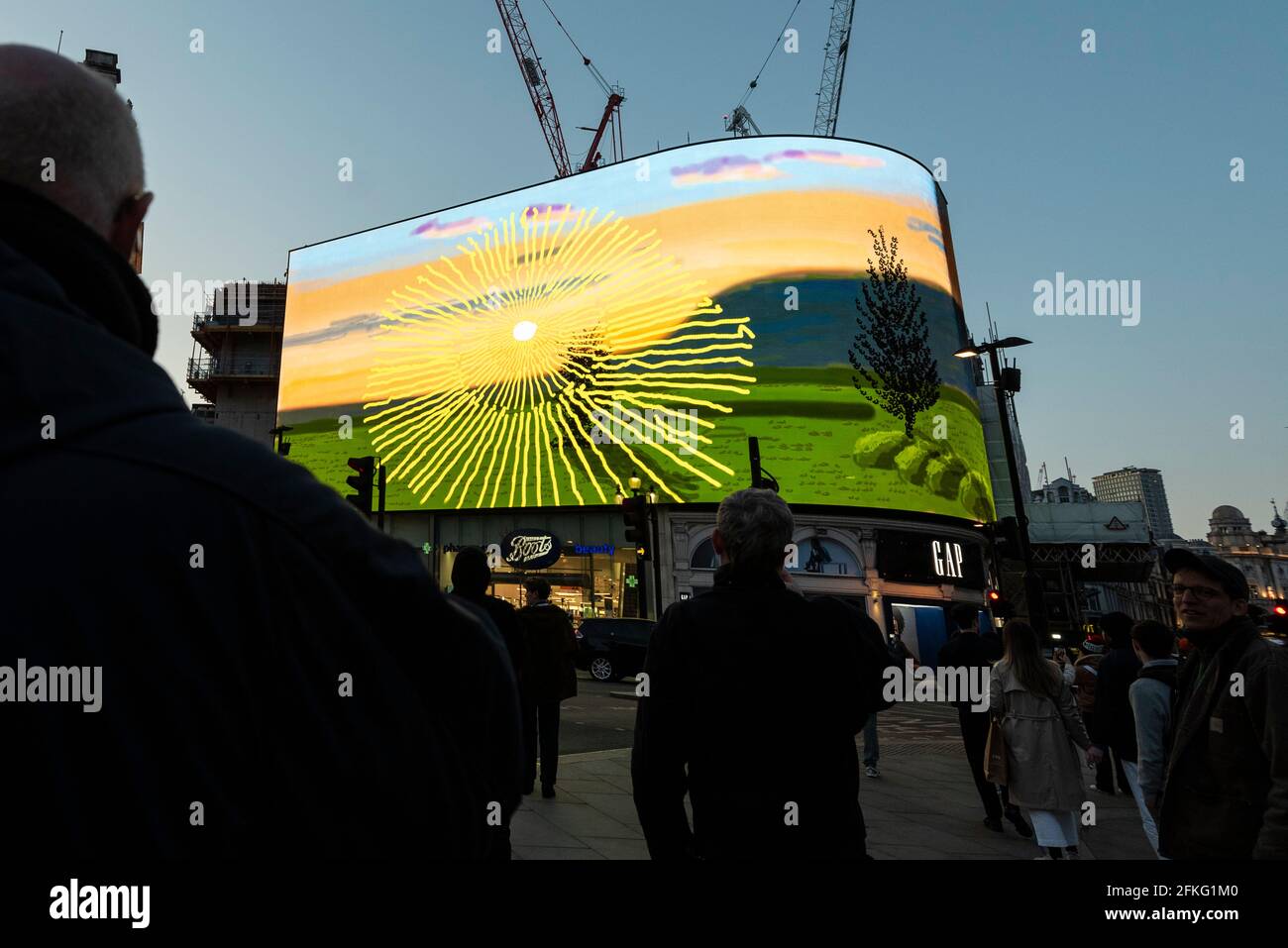 London, UK.  1 May 2021.  David Hockney’s “Remember You Cannot Look At The Sun Or Death For Very Long” artwork, showing an animated sunrise, is displayed on the giant screens at Piccadilly Circus.  It will also be displayed on screens in other cities worldwide.  The work, created on an iPad, is supposed to offer a symbol of hope as the world awakens from its long lockdown and also coincides with his upcoming “The Arrival of Spring” exhibition at the Royal Academy.  In London, the work is on display nightly for the month of May.  Credit: Stephen Chung / Alamy Live News Stock Photo