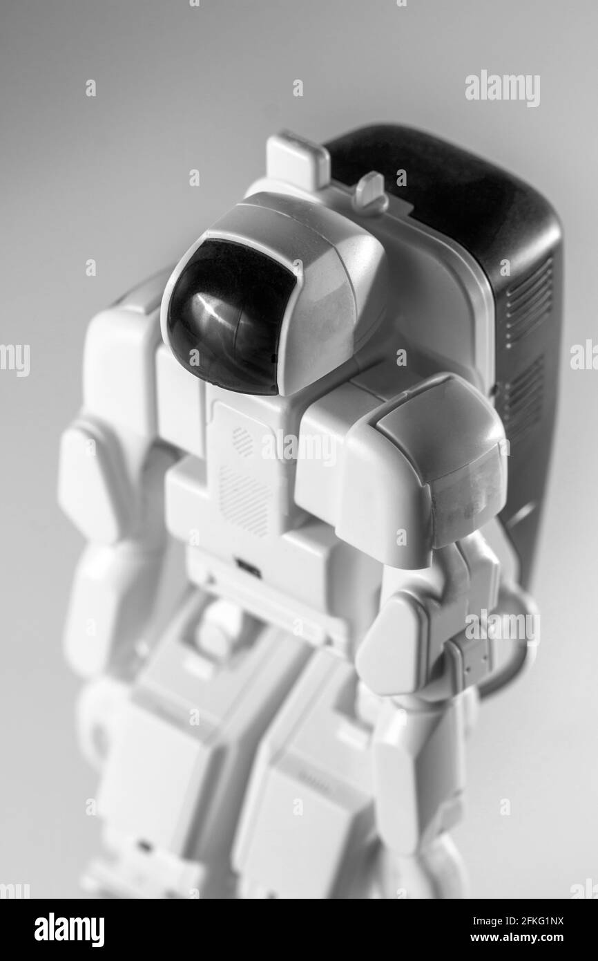 Modern advanced autonomous robot toy isolated on a gray background