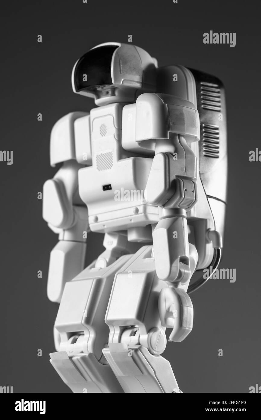 Modern advanced autonomous robot toy isolated on a gray background