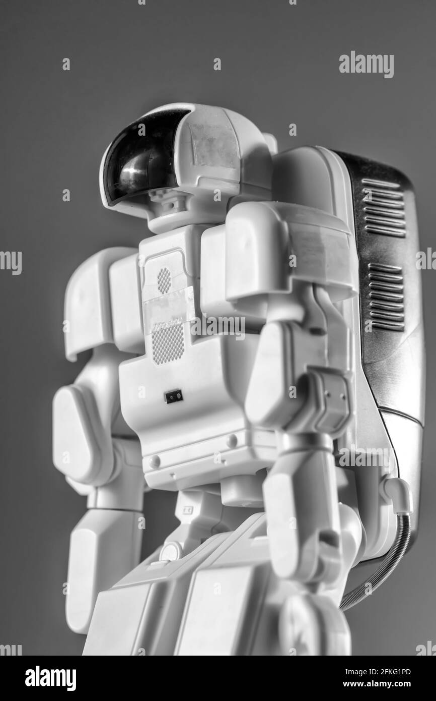 Modern advanced autonomous robot toy isolated on a gray background
