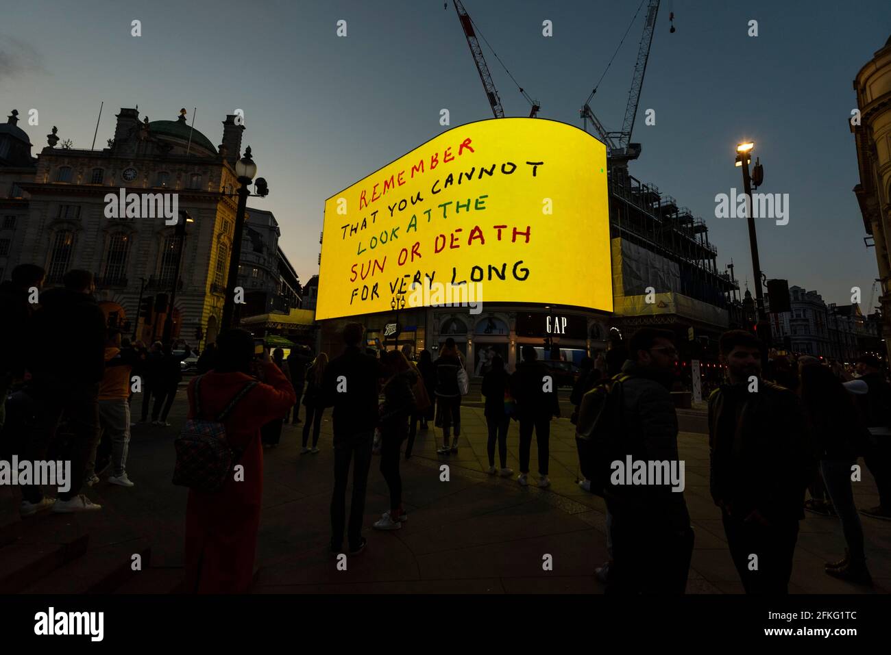 London, UK.  1 May 2021.  David Hockney’s “Remember You Cannot Look At The Sun Or Death For Very Long” artwork, showing an animated sunrise, is displayed on the giant screens at Piccadilly Circus.  It will also be displayed on screens in other cities worldwide.  The work, created on an iPad, is supposed to offer a symbol of hope as the world awakens from its long lockdown and also coincides with his upcoming “The Arrival of Spring” exhibition at the Royal Academy.  In London, the work is on display nightly for the month of May.  Credit: Stephen Chung / Alamy Live News Stock Photo