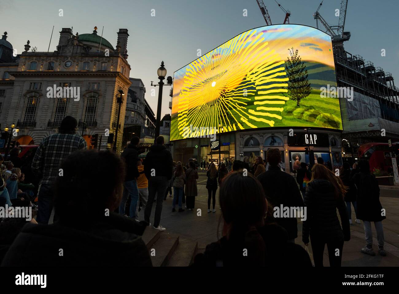 London, UK.  1 May 2021.  David Hockney’s “Remember You Cannot Look At The Sun Or Death For Very Long” artwork, showing an animated sunrise, is displayed on the giant screens at Piccadilly Circus.  It will also be displayed on screens in other cities worldwide.  The work, created on an iPad, is supposed to offer a symbol of hope as the world awakens from its long lockdown and also coincides with his upcoming “The Arrival of Spring” exhibition at the Royal Academy.  In London, the work is on display nightly for the month of May.  Credit: Stephen Chung / Alamy Live News Stock Photo