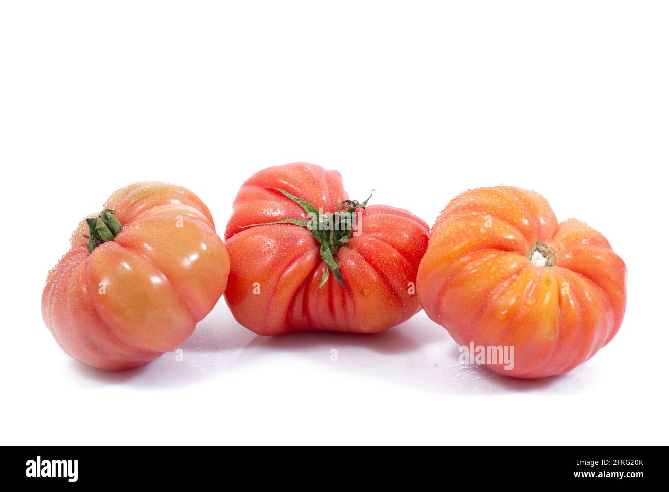 Group of Beef heart tomatos isolated on a white background Stock Photo ...