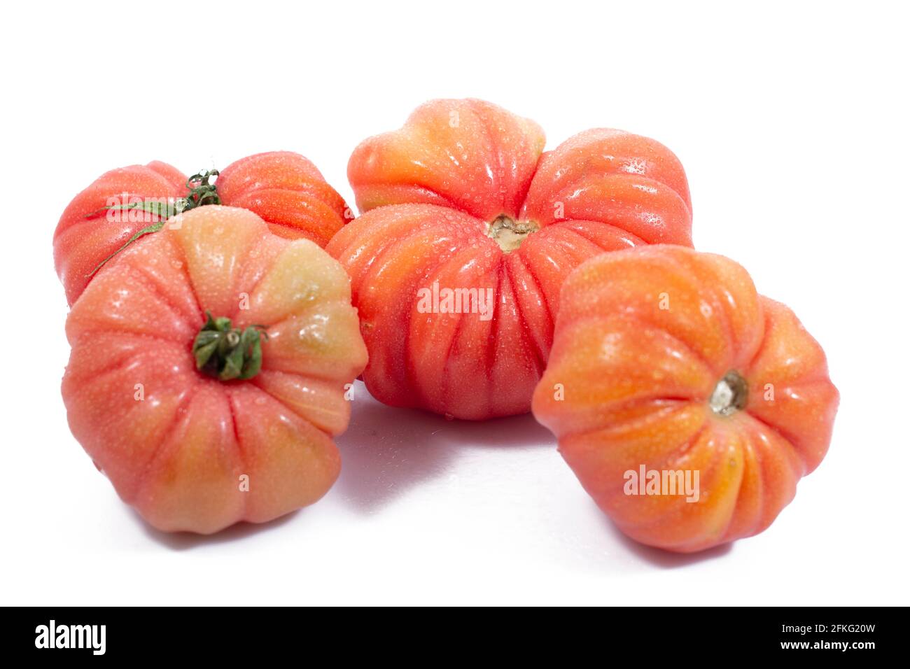 Group of Beef heart tomatos isolated on a white background Stock Photo ...