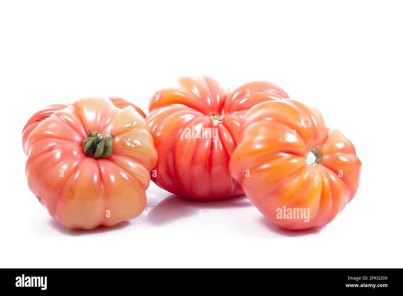 Group of Beef heart tomatos isolated on a white background Stock Photo ...