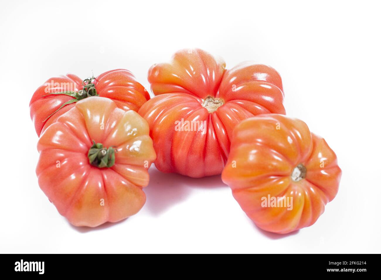 Group of Beef heart tomatos isolated on a white background Stock Photo ...