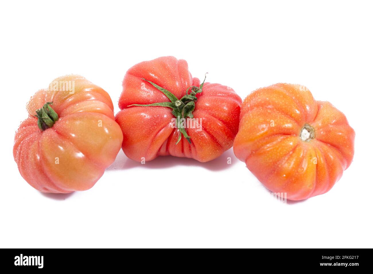 Group of Beef heart tomatos isolated on a white background Stock Photo ...