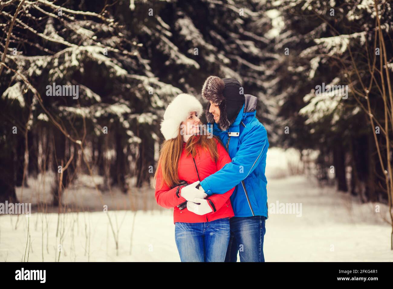 romantic couple in winter park embracing Stock Photo - Alamy