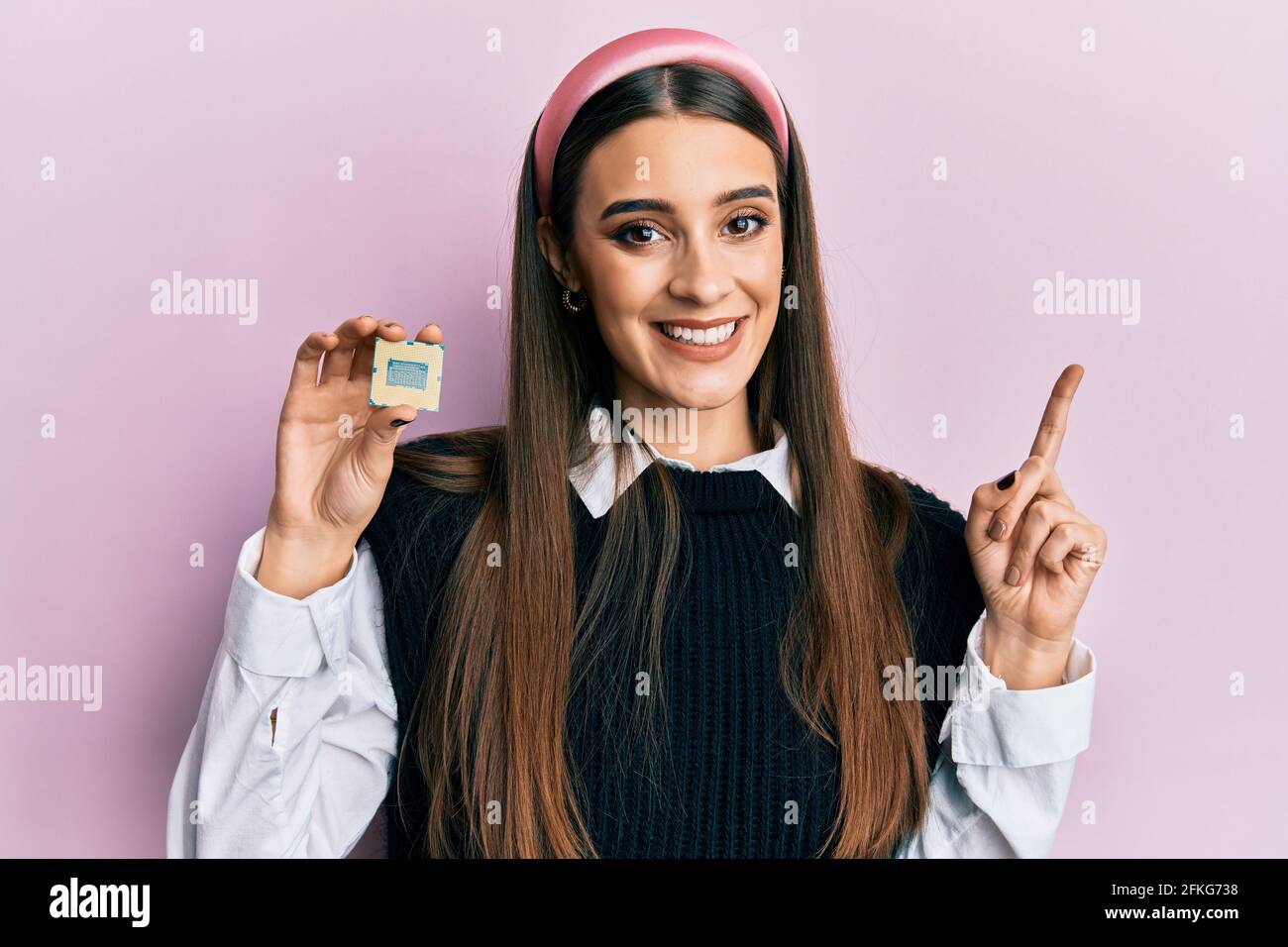 Beautiful brunette young woman holding cpu processor computer smiling ...