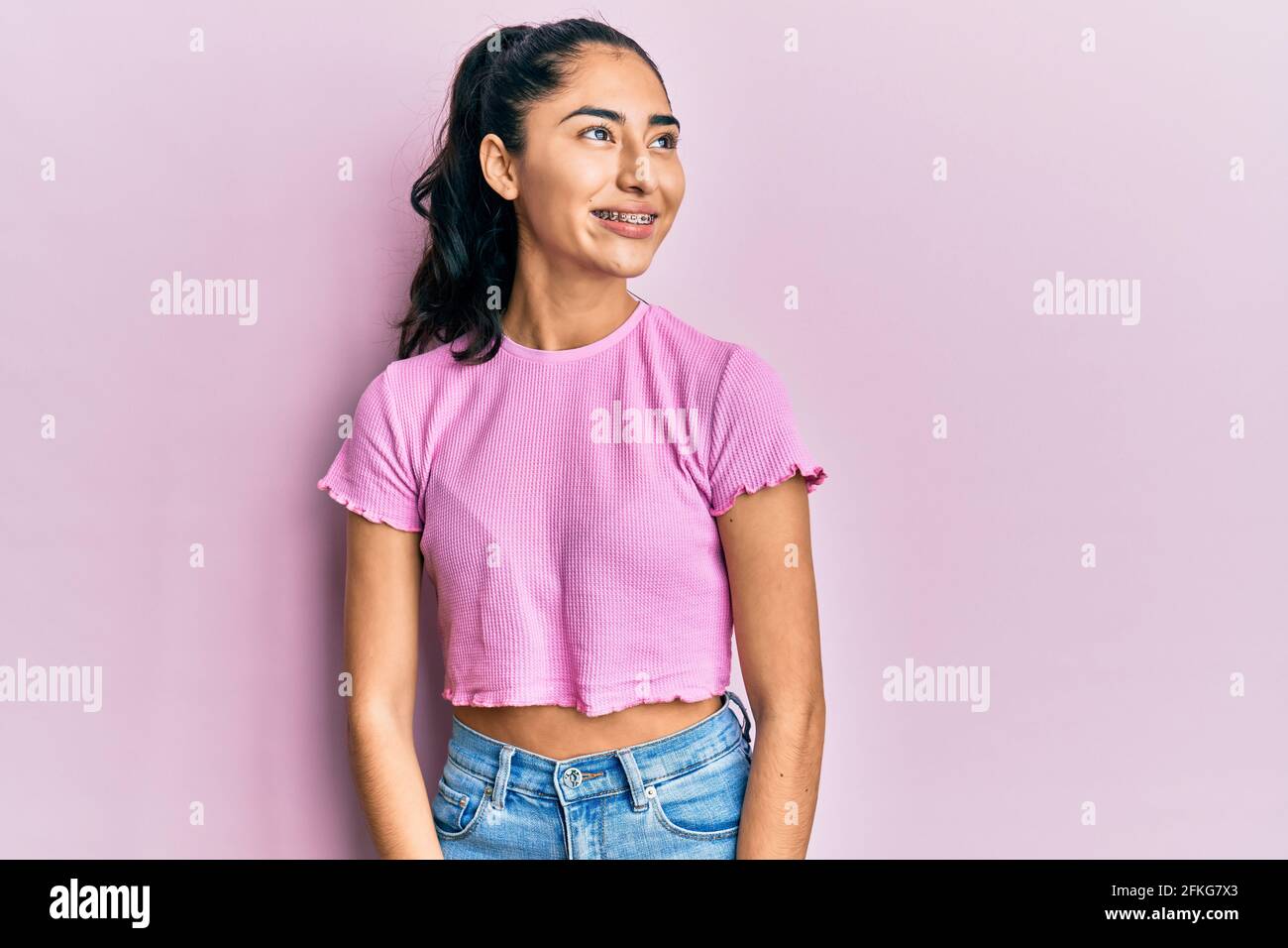 Hispanic Poses Hispanic teenager girl with dental braces wearing casual clothes ...