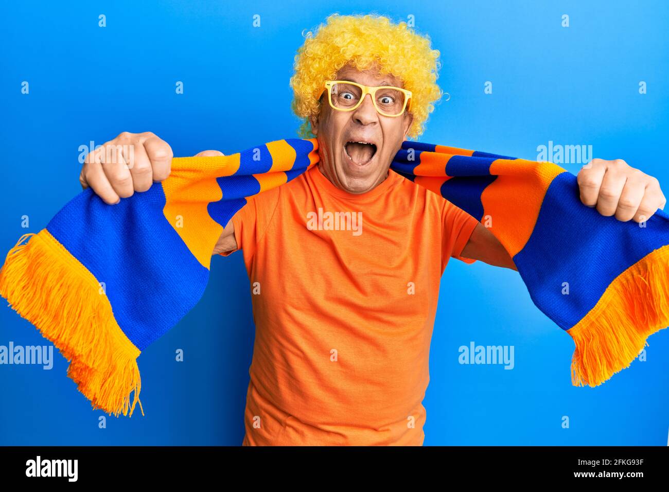 Senior hispanic man football hooligan cheering game celebrating crazy ...