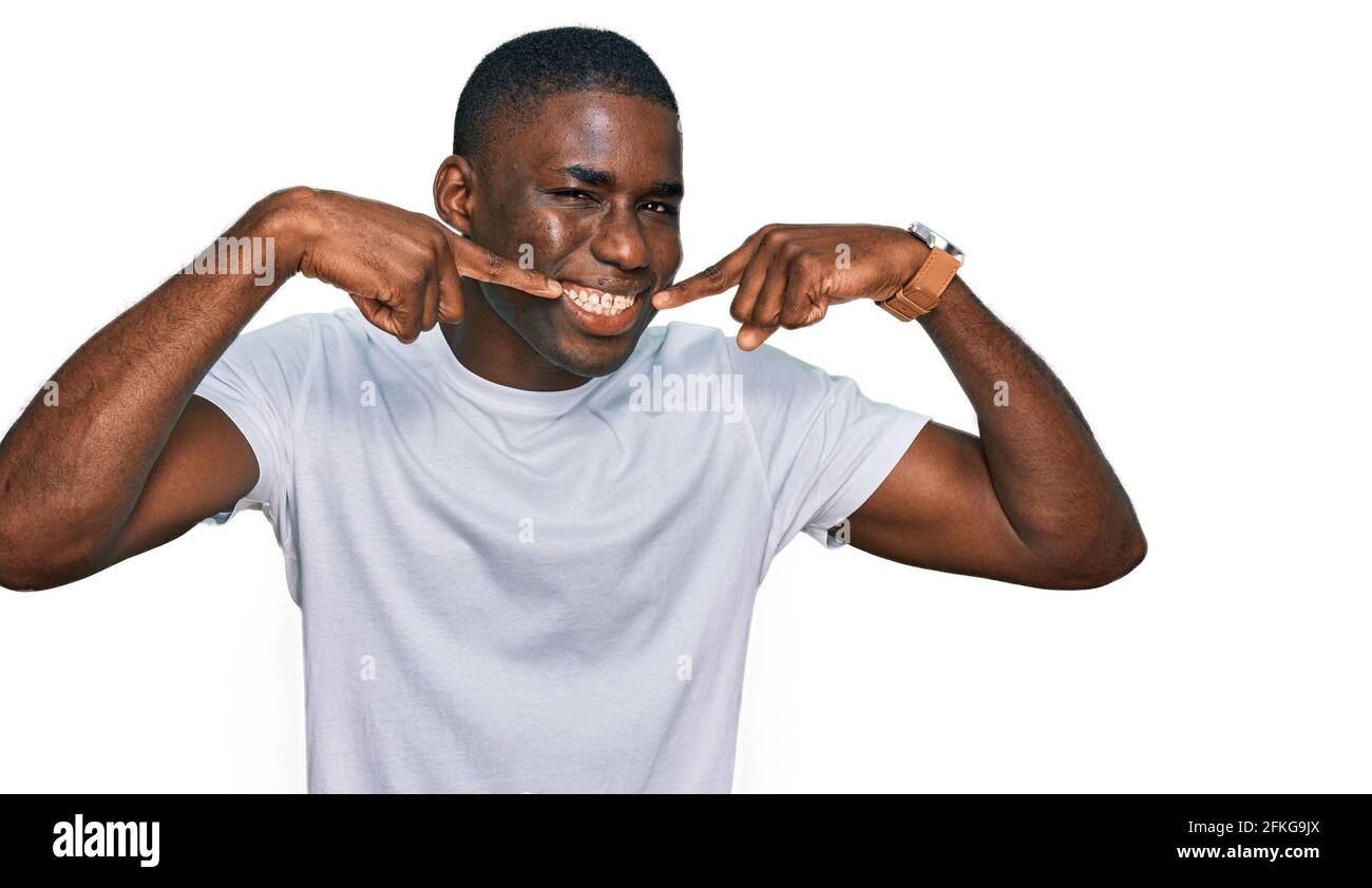 Young african american man wearing casual white t shirt smiling ...