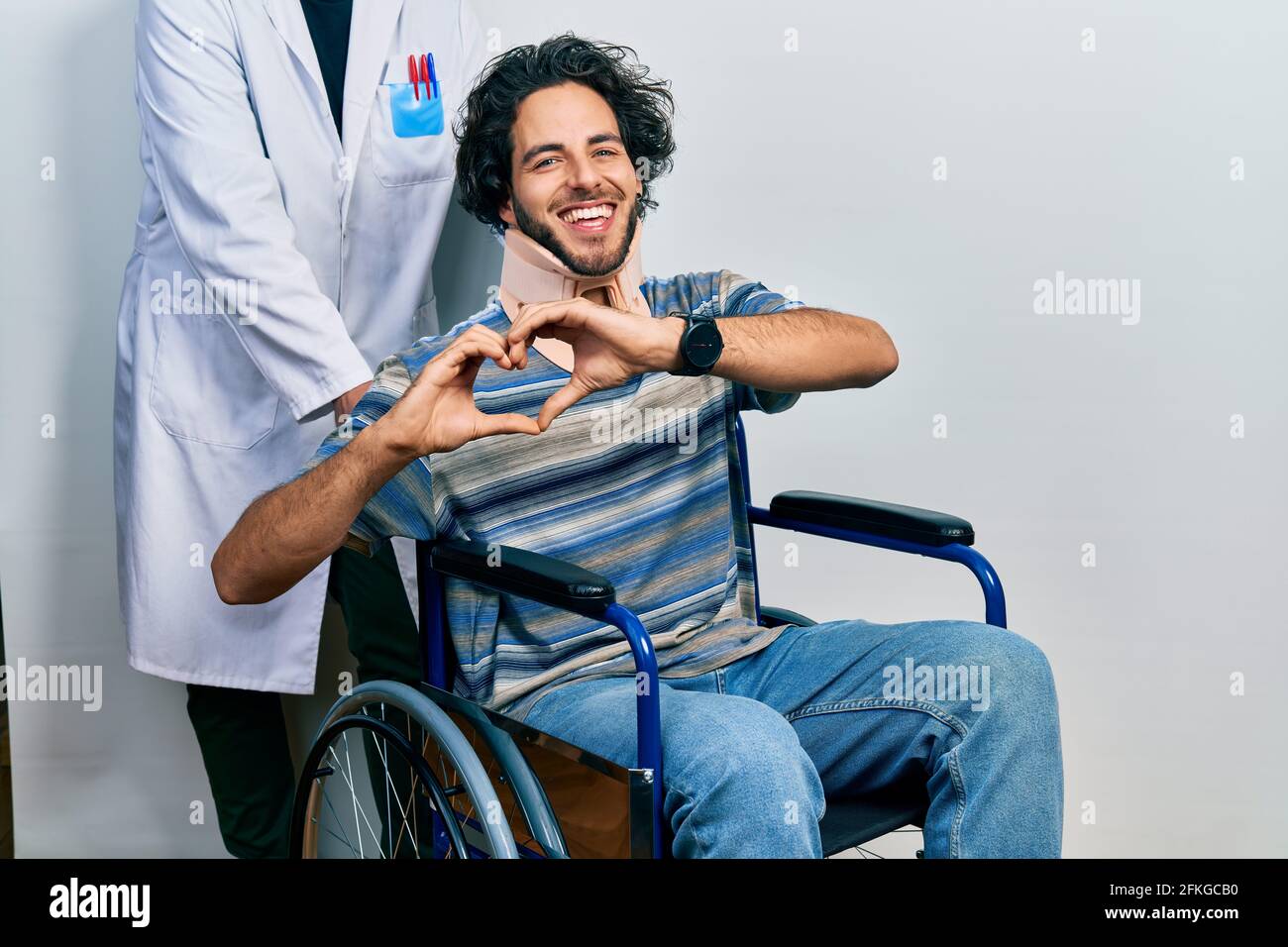 Handsome Hispanic Man Sitting On Wheelchair Wearing Neck Collar Smiling 