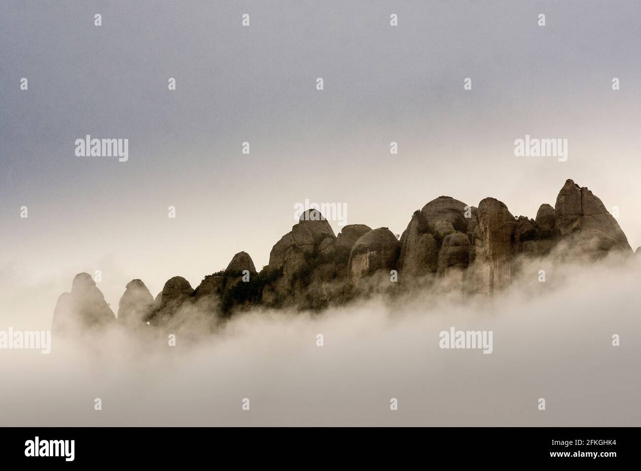 Rising clouds and mist obscure the peaks of Catalonia’s most famous natural landmark in the early morning after some heavy rainfall, resulting in moisture engulfing the peaks of the Montserrat mountain range, west of Barcelona in the province of Catalonia, Spain. © Olli Geibel Stock Photo